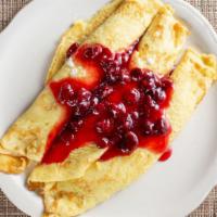 Cherry Kijafa Crepes · A Danish favorite. Three delicate crepes filled with tart red cherries simmered in our Kijaf...