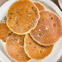 Blueberry Pancakes · Buttermilk pancakes filled with blueberries. Lightly dusted with powdered sugar. Served with...