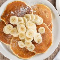 Banana Pancakes · Dusted with powdered sugar. Served with whipped butter and tropical syrup. 920 cal.