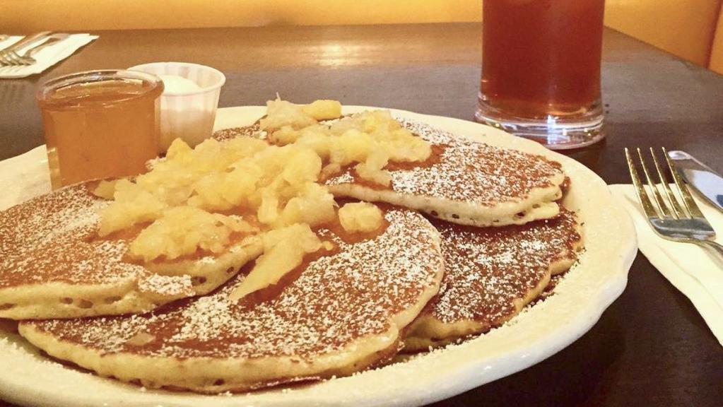 Hawaiian Pancakes · Our fresh buttermilk pancakes filled with crushed pineapple and lightly dusted with powdered sugar, served with whipped butter and hot tropical syrup. (cooked with peanut oil).