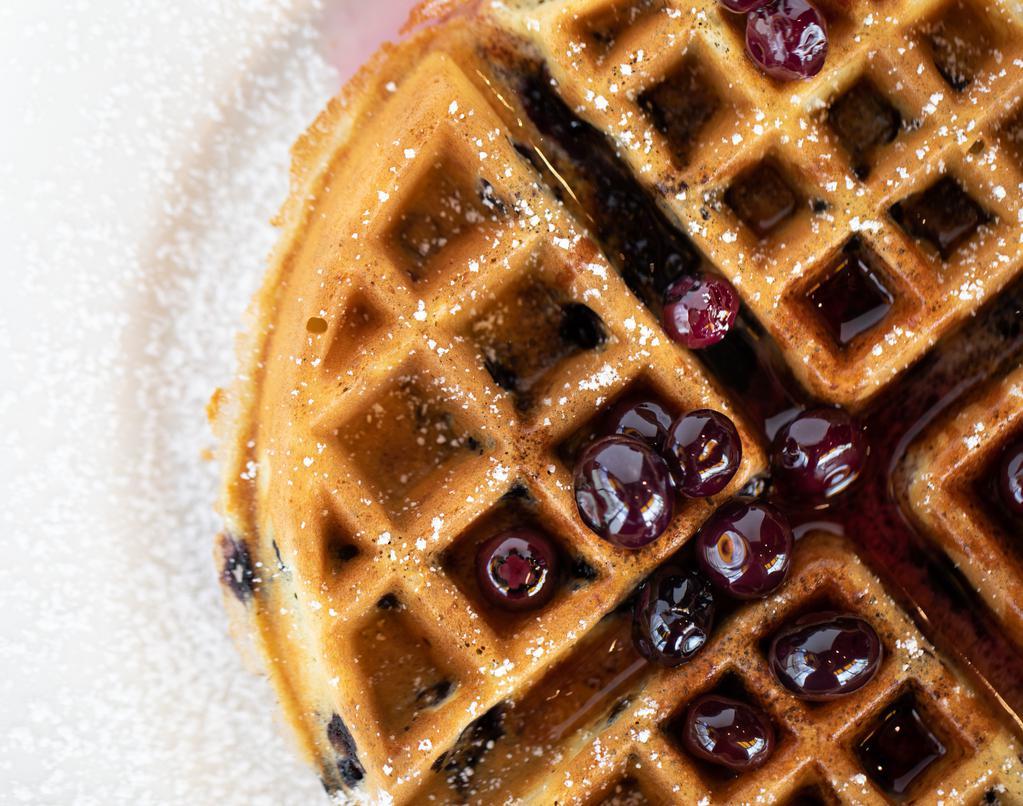 Blueberry Waffle · Our golden brown waffle baked with delicious, plump blueberries and lightly dusted with powdered sugar. Served with whipped butter and hot blueberry compote.