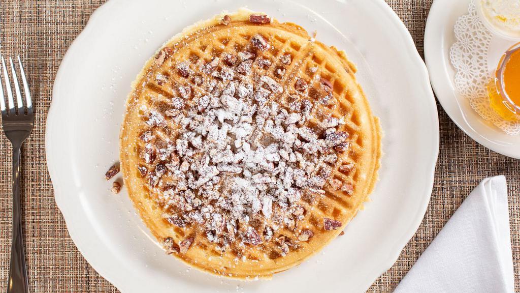 Pecan Waffle · Our golden brown waffle baked with chopped pecans, served with whipped butter and hot tropical syrup.