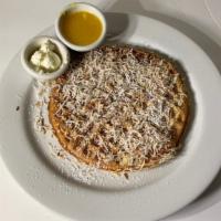 Coconut Waffle · Our golden brown waffle filled and topped with toasted coconut and lightly dusted with powde...