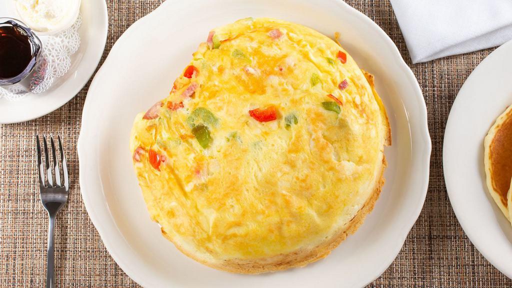 Western Omelette · Loaded with diced hickory-smoked ham, fresh sautéed red and green bell peppers, onions and pepper jack cheese. Accompanied by a side of your choice of salsa made in house. (2,030 Cal.)