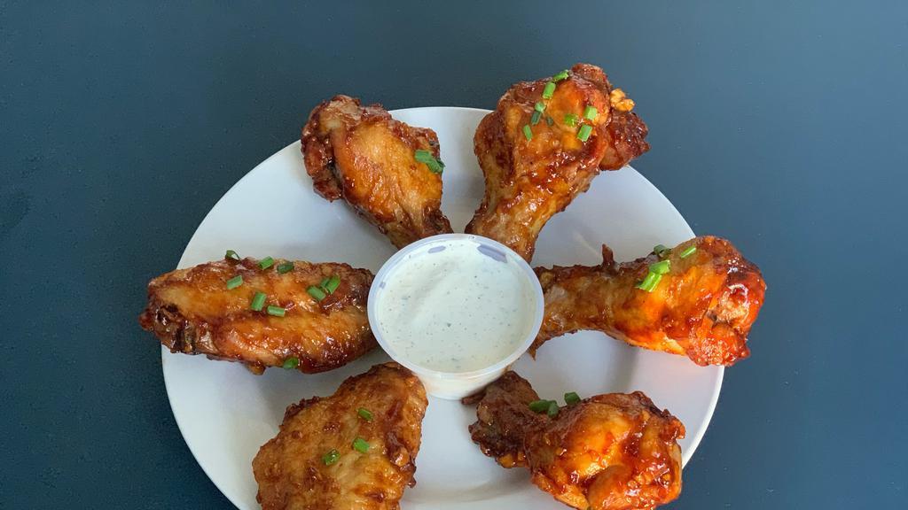 Thai Chicken Wings · Tossed with a glaze of Thai curry paste, lemongrass, brown sugar, soy sauce, and coconut milk. Served with blue cheese dip.