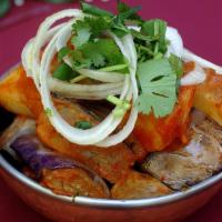 Eggplant & Potato · Vegan. Wedges of eggplant and potato, tossed with onions, tomatoes, mustard, cumin, and dash...