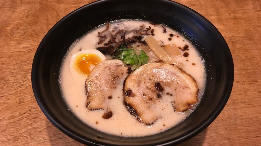 Tonkotsu Ramen · Pork soup base: chashu pork, green onion, bamboo shoots, half-boiled egg, kikurage mushroom,  and  garlic oil.