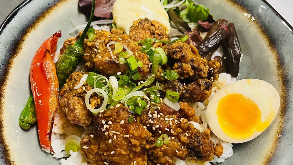 Regular Karaage Don · Chicken Karaage tossed in teriyaki-pepper sauce over rice, topped with green onion, peppers, salad, mayo, pickles  and sesame seeds.