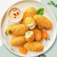 Jalapeno Poppers · 6 pieces of golden deep-fried jalapeños filled with cream cheese.
