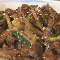 Mongolian Beef · Slices of beef sautéed with yellow and green onions and bell peppers in spicy Mongolian sauce.