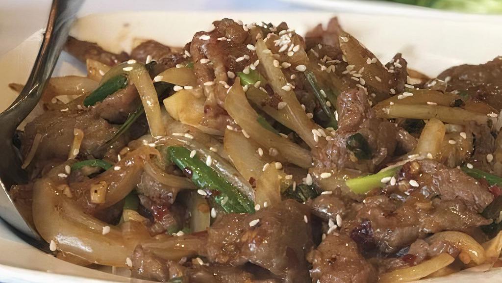 Mongolian Beef · Slices of beef sautéed with yellow and green onions and bell peppers in spicy Mongolian sauce.