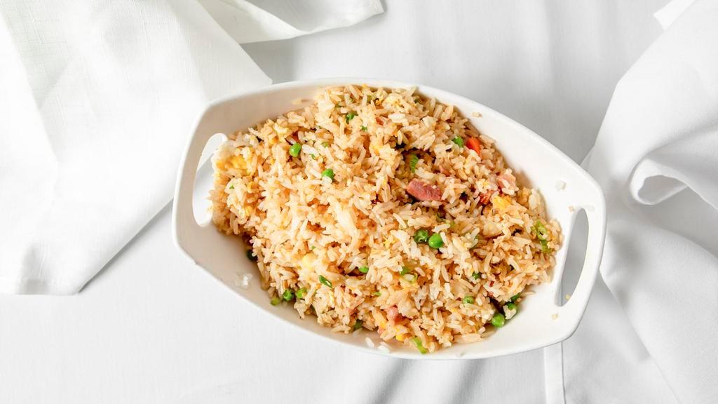 Fried Rice · Gluten-free. Wok-fried rice blended with eggs, wheat-free soy sauce, green onions, peas and carrots.