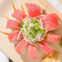 Cherry Blossom · Inside: spicy tuna and shrimp tempura, cucumber. Outside: fresh slice tuna cover the whole r...
