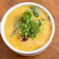 Dal Soup Bowl · A hearty bowl of spiced dal soup over quinoa and topped with cilantro, raisin chutney, and g...