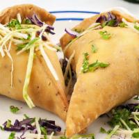Veggie Samosa · Crispy indian wafers filled with potatoes and peas. Deep-fried to perfection.