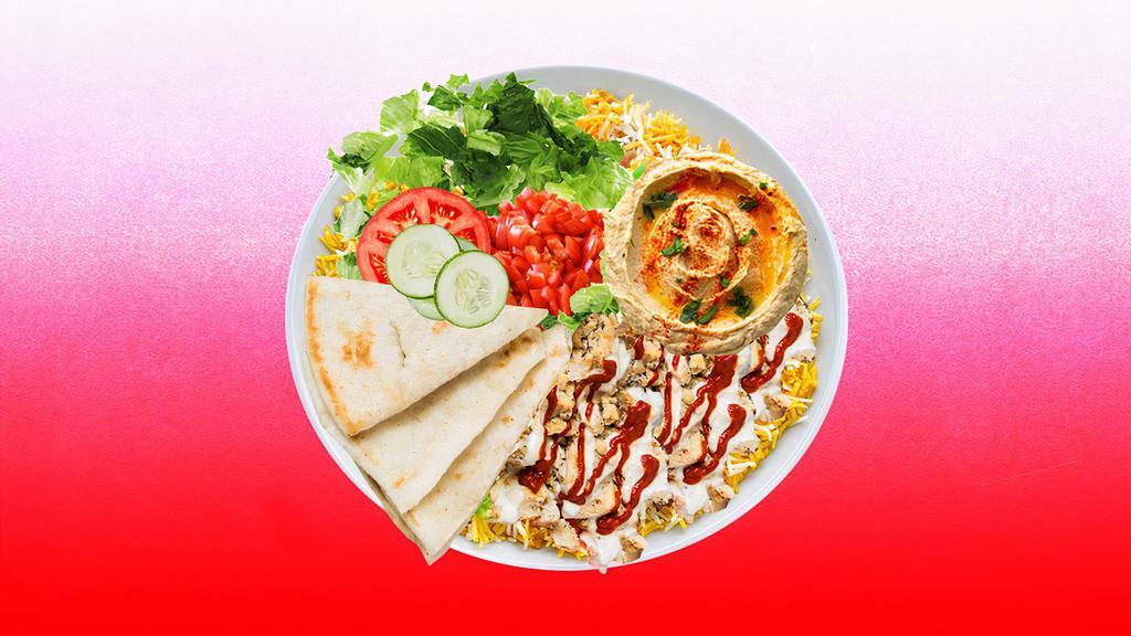 Spicy Chicken Shawarma Hummus Platter · Tender chicken shawarma over hummus and topped with spicy red sauce.  Served with cucumber & tomato salad, leafy greens, white sauce, and pita.