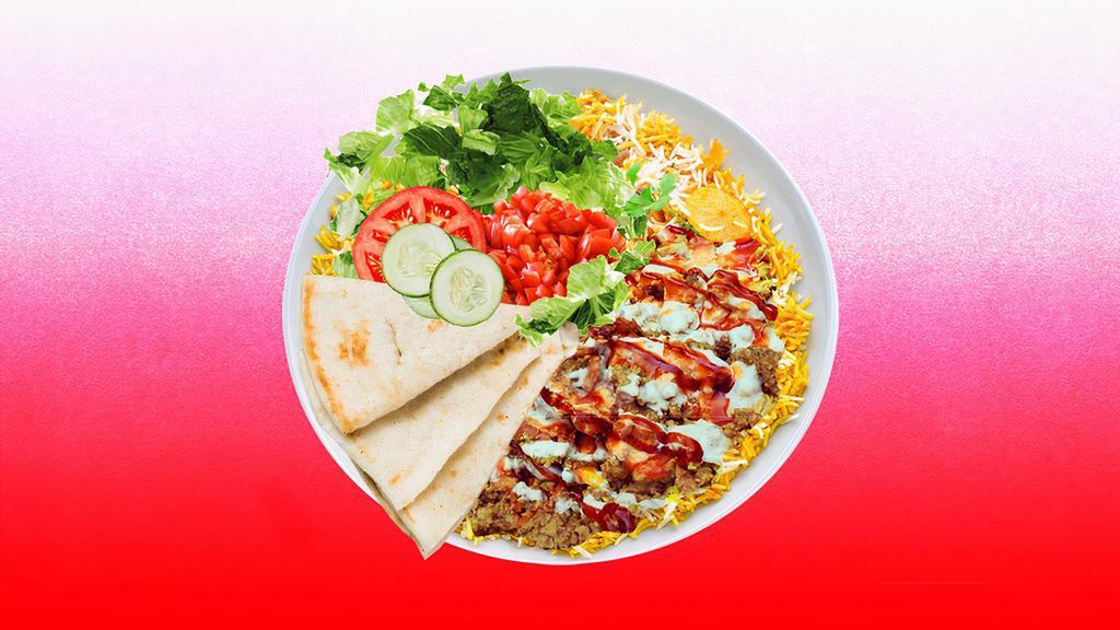 Spicy Beef Shawarma Rice Platter · Juicy beef shawarma over rice and topped with spicy red sauce.  Served with cucumber & tomato salad, leafy greens, white sauce, and pita.