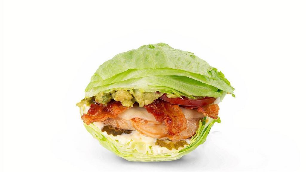 Cali Chicken Lettuce Wrap · Grilled chicken, house-made guac, hardwood-smoked bacon, Provolone, pickles, lettuce, tomatoes and mayo in a lettuce wrap.