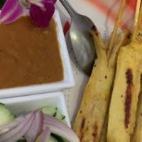 Chicken Satay (5 Skewers) · Grilled chicken on skewers marinated with Thai spices served with peanut sauce and cucumber ...