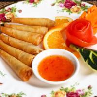 Goong Krabork (Shrimp Rolls) · Marinated shrimps wrapped with egg roll skin served with sweet and sour sauce