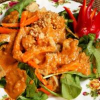 Pra Ram · Choice of sliced chicken, beef or pork with spinach topped with peanut sauce served over ste...