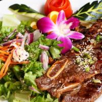 BBQ Short Ribs · A Korean style of BBQ short ribs served with house green salad and spicy sauce.