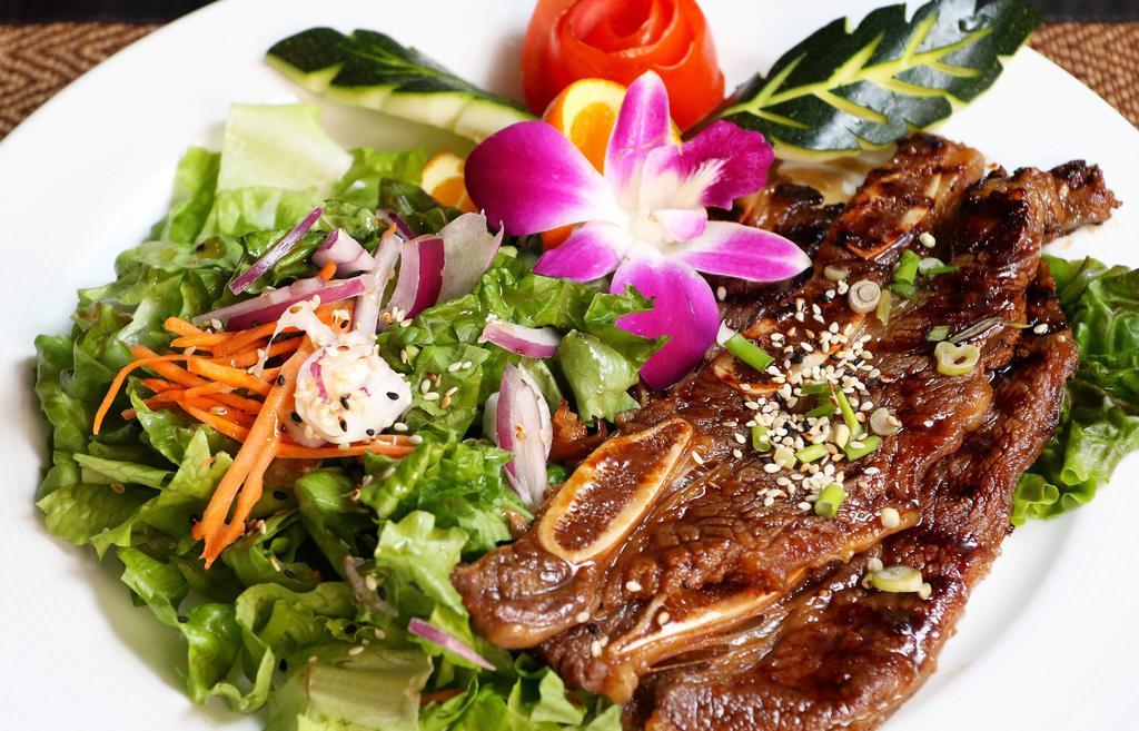 BBQ Short Ribs · A Korean style of BBQ short ribs served with house green salad and spicy sauce.