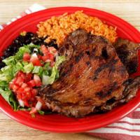 Carne Asada · Carne Asada, brushed with peppercorn and olive oil marinade; served with rice, beans, and to...