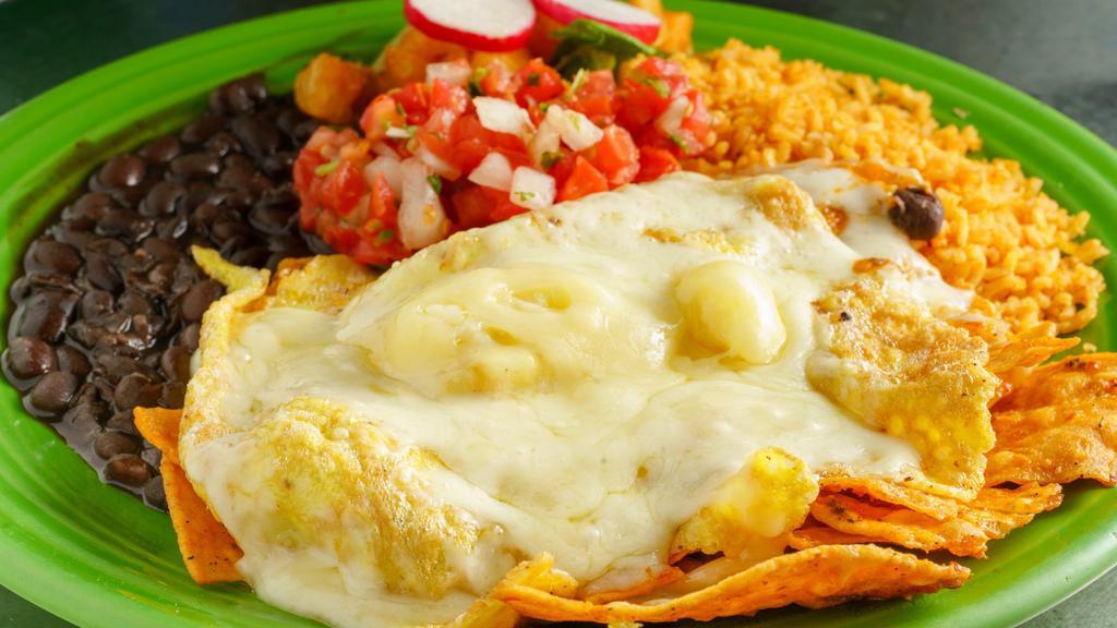 Chilaquiles · Tortilla strips cooked in our famous roasted salsa and cheese with or without eggs. Served with rice and beans.
