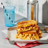 The Mac Attack · Gooey mac and cheese and bacon bits grilled between two slices of buttered bread.