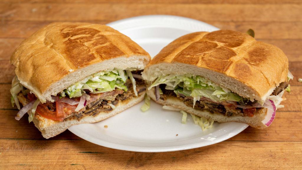 Milanesa · Breaded steak, tomatoes, red onions, jalapeños, lettuce, Swiss cheese, avocado and mayonnaise.