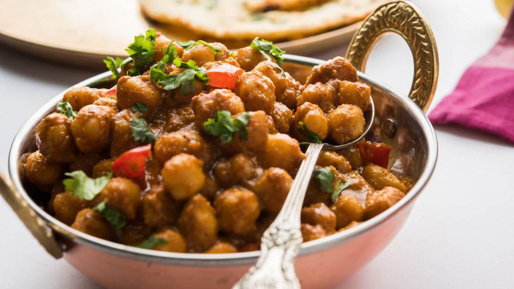 Chana Masala · Garbanzo beans cooked with herbs and spices.
