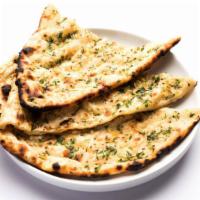 Garlic Naan · Fresh bread baked in clay oven topped with fresh garlic and cilantro.