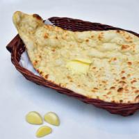 Garlic Roti · Fresh whole wheat bread baked in clay oven with garlic and cilantro.