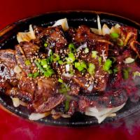 Beef Short Ribs (갈비) · Sweet, tender beef short ribs served with rice