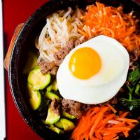 Stone Pot Rice Bowl (돌솥비빔밥) · Sizzling stone pot. Beef, spinach, carrots, radish, bean sprouts & egg. Add mild red sauce &...