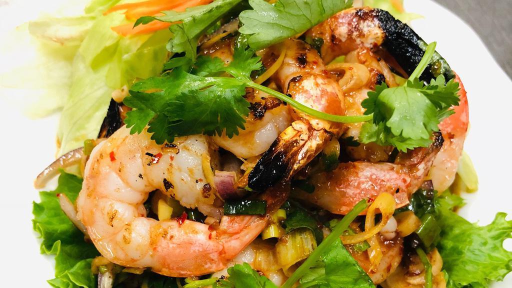 Grilled Prawns Salad · Grilled prawns mixed with lemongrass, onion, and cilantro in lime juice and sweet chili sauce bedded with lettuce.