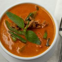 Panang Curry · Thick brown curry in coconut milk with a touch of peanut sauce with string bean, bell pepper...