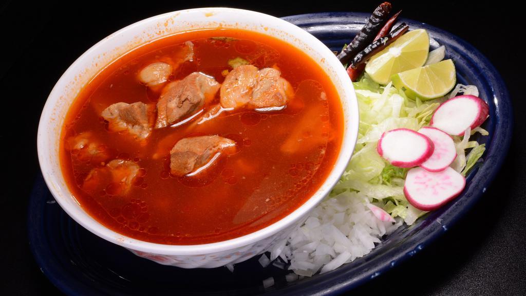 Pozole · Pork soup and hominy served with lettuce, radish, onions, and tostadas.