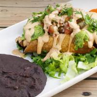 Flautas de Camote · Two rolled crispy tacos with sweet potato and caramelized. onion. Topped with guacamole, pic...