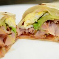 9. Sutter Supreme Wrap · with both Ham and Sausage or bacon, eggs, cheese, avocado, sun-dried tomato/salsa on Tortill...