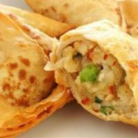 Vegetable Samosa · Fried triangular flour shell filled with potatoes & peas with chutney