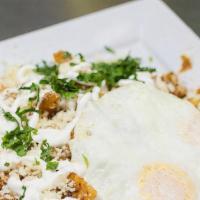 Chilaquiles · Beef chorizo, corn chips, fresh corn, queso fresco, sour cream, jalapeño, over-easy eggs, an...