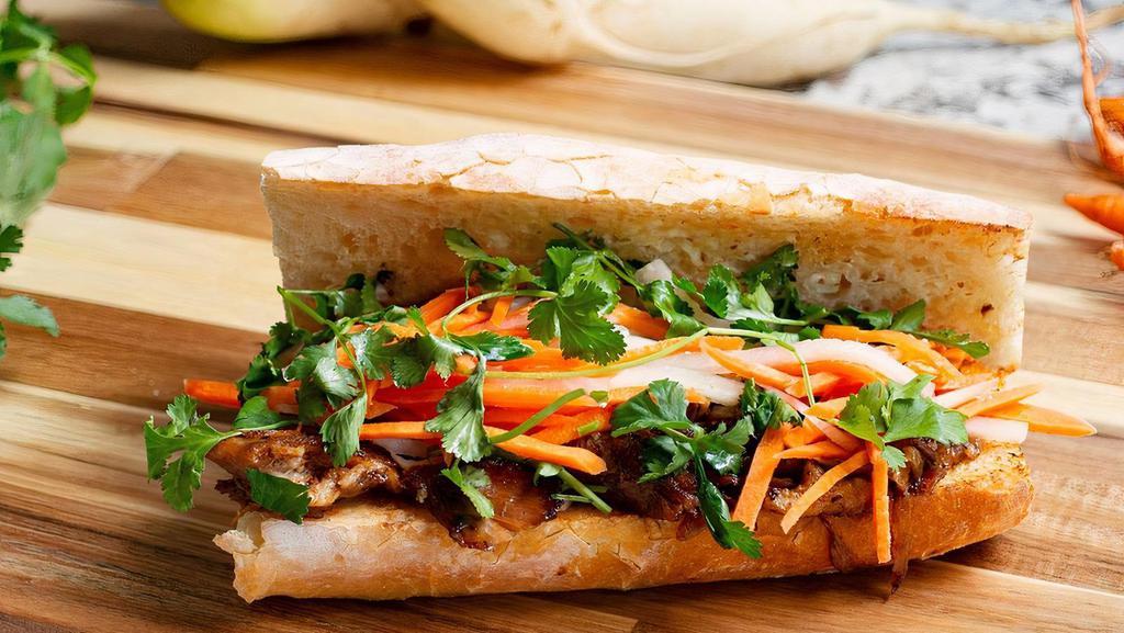 Duck Banh Mi · Duck Confit, Vietnamese Marinade, Pickled Carrots and Daikon, Cilantro, freshly sliced Jalapeno on a Homemade Baguette