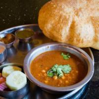 Chana Batura · Deep fried white bread served with spicy chick peas curry.