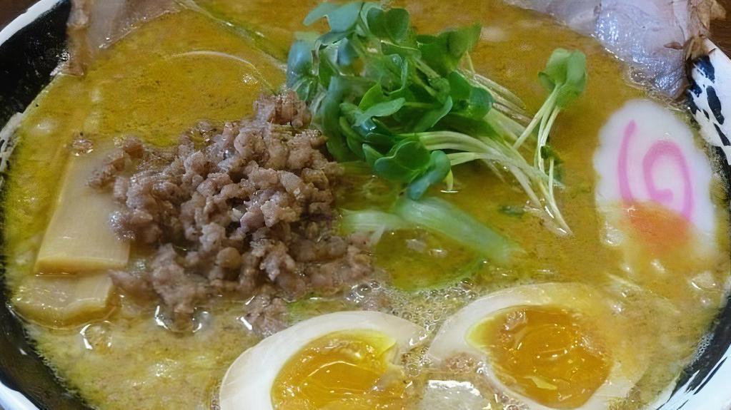 Curry Ramen · Curry soy sauce broth with chashu pork, ground pork, egg, bamboo, kaiware sprouts, naruto fish cake, and green onion.