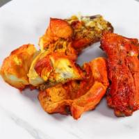 36. Chicken Tandoori (on The Bones) · Roasted chicken marinated in mildly spiced sauce.