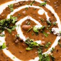 72. Dal Makhani (Lentils) · Creamed black lentils in a mixture of spices. Served with Rice