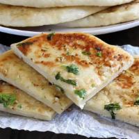 26. Cheese Naan · Naan stuffed with cheese.