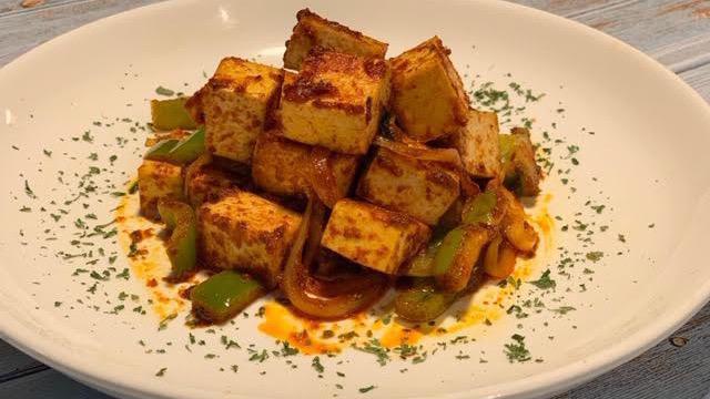 Tofu Tibs · Fresh seasonal tofu stir-fried in a blend of native Ethiopian spices and sautéed with onions, tomatoes, garlic, bell pepper and berbere. Served with Injera or Turmeric Rice.